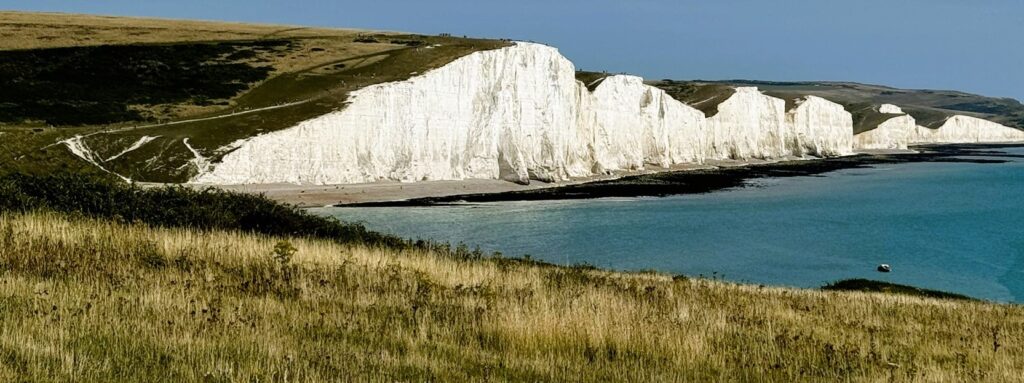 Chalk cliffs and coastal grassland in southern England symbolising biodiversity validation in planning and compliance with Biodiversity Net Gain (BNG) requirements.