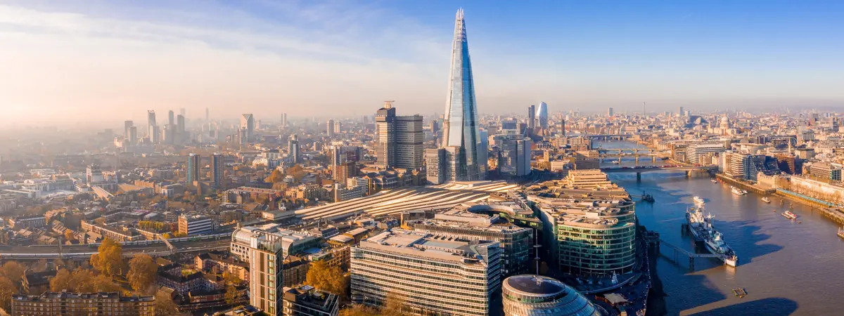The River Thames beside buildings and transport infrastructure in London.